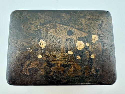 fig 1. An early 19th-century rectangular black lacquer box with gilded painted Chinese figural scenes on the lid.