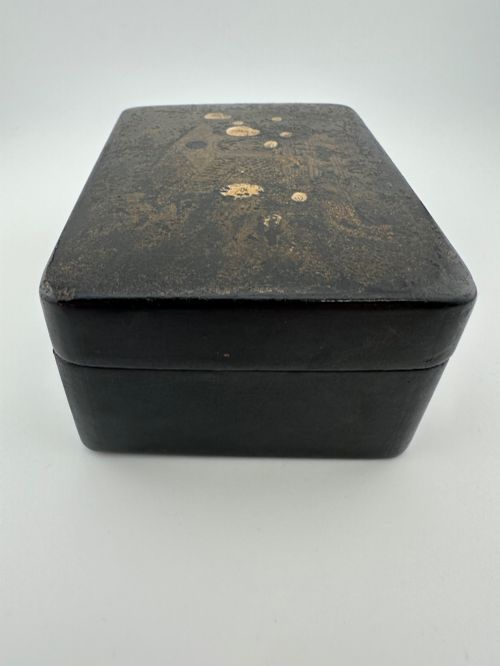 fig 3. An early 19th-century rectangular black lacquer box with gilded painted Chinese figural scenes on the lid.