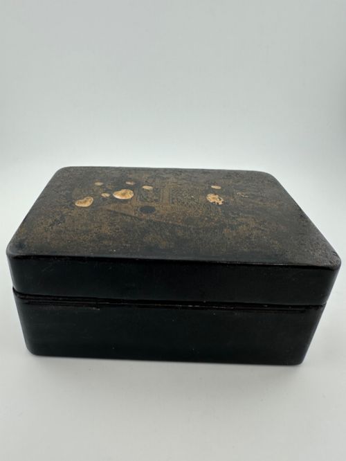 fig 4. An early 19th-century rectangular black lacquer box with gilded painted Chinese figural scenes on the lid.