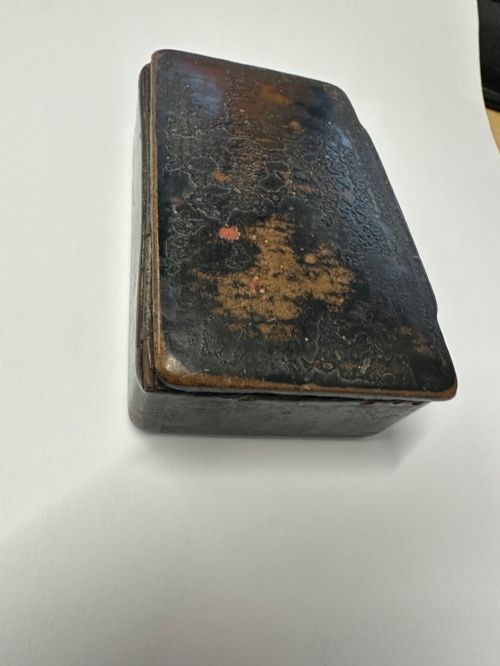 fig 1. A small rectangular mid-19th-century Chinese export black lacquer box with a gilded decorated lid showing surface age and patina.