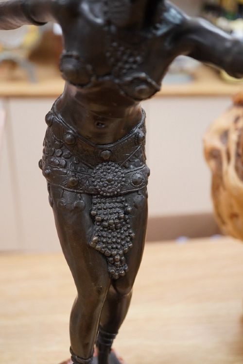 fig 2. An Art Deco style dark bronze figurine depicting an exotic female dancer with outstretched arms mounted on a stepped red and white marble plinth.