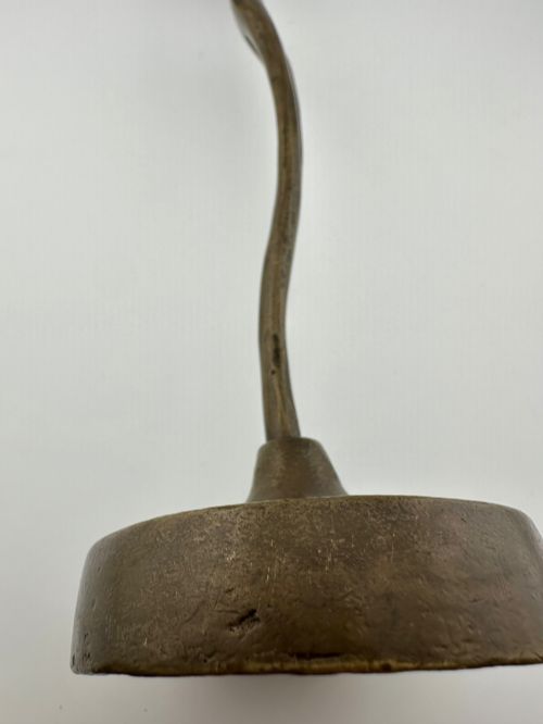 fig 4. A slender modernist bronze sculpture depicting an abstract female dancer with raised arms set upon a round metal base.