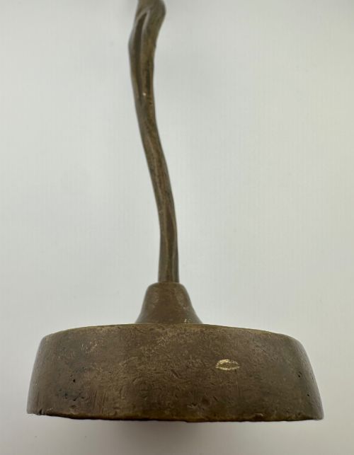fig 5. A slender modernist bronze sculpture depicting an abstract female dancer with raised arms set upon a round metal base.