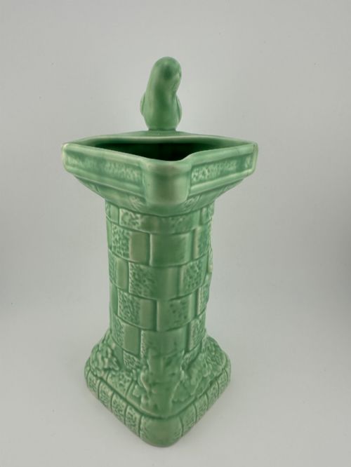 fig 1. A pale green glazed earthenware Art Deco ceramic jug featuring relief brickwork and a sculpted bird perched on the handle.