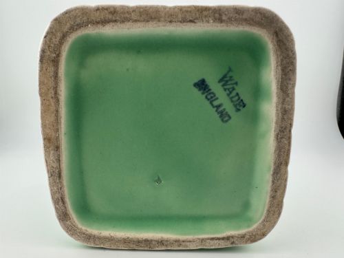 fig 4. A pale green glazed earthenware Art Deco ceramic jug featuring relief brickwork and a sculpted bird perched on the handle.