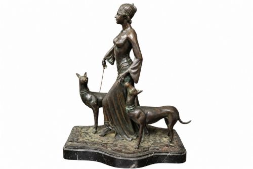 fig 1. A dark bronze Art Deco sculpture depicting a stylised woman walking two greyhounds on thin chains, set on a dark polished marble base.