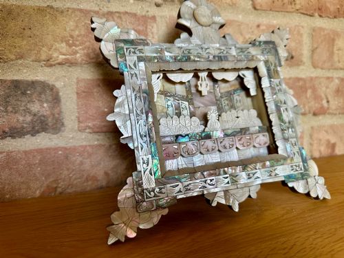 fig 4. An antique hand-carved mother of pearl and abalone shell diorama frame depicting the Last Supper with elaborate cresting.
