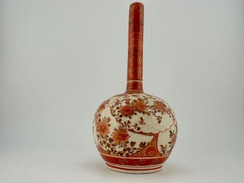 fig 2. A Japanese Kutani porcelain bottle vase with a tall narrow neck, featuring iron red and gilt floral decoration over a cream crackle glaze body.