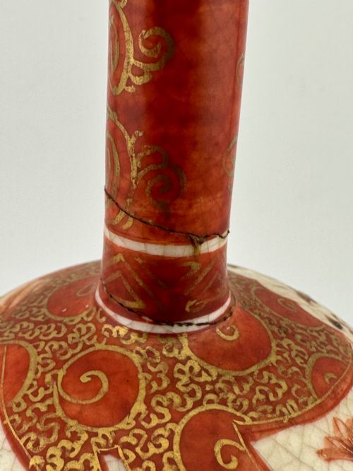 fig 3. A Japanese Kutani porcelain bottle vase with a tall narrow neck, featuring iron red and gilt floral decoration over a cream crackle glaze body.