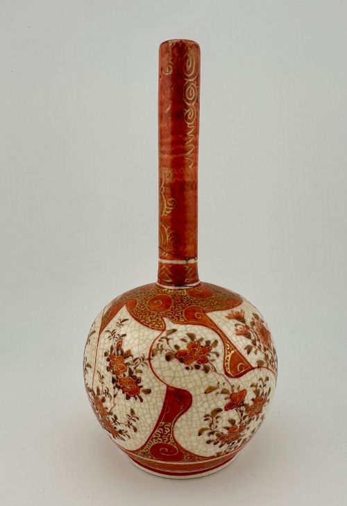 fig 4. A Japanese Kutani porcelain bottle vase with a tall narrow neck, featuring iron red and gilt floral decoration over a cream crackle glaze body.