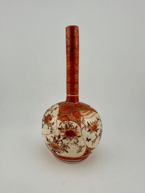 fig 5. A Japanese Kutani porcelain bottle vase with a tall narrow neck, featuring iron red and gilt floral decoration over a cream crackle glaze body.