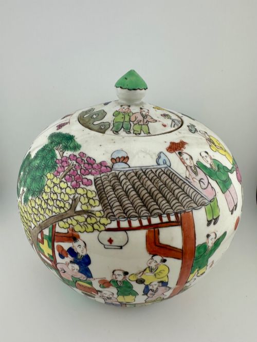 fig 2. A rounded white porcelain covered jar featuring hand-painted colourful enamels depicting a dragon festival procession with children.