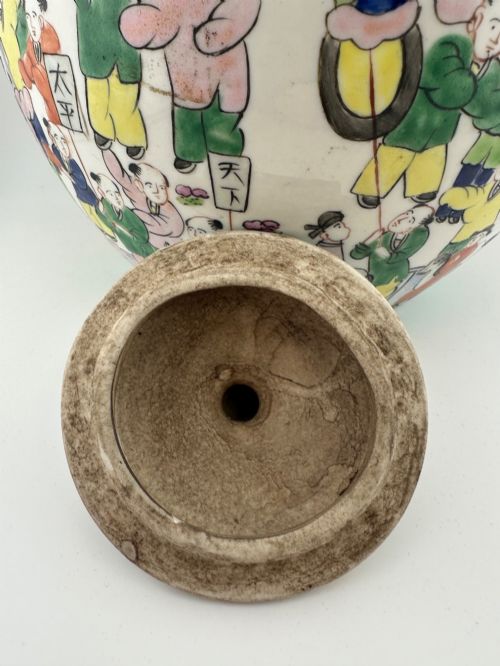 fig 6. A rounded white porcelain covered jar featuring hand-painted colourful enamels depicting a dragon festival procession with children.