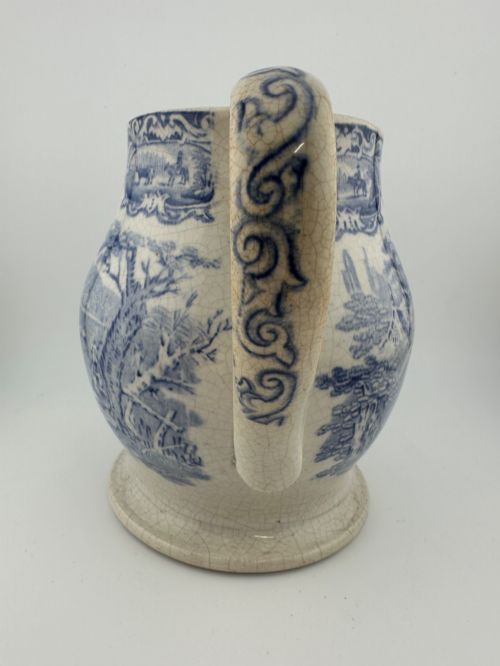 fig 2. An early Victorian blue and white transferware ceramic jug featuring a pastoral cattle scene with fine glaze crazing throughout.