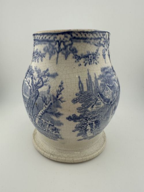 fig 4. An early Victorian blue and white transferware ceramic jug featuring a pastoral cattle scene with fine glaze crazing throughout.