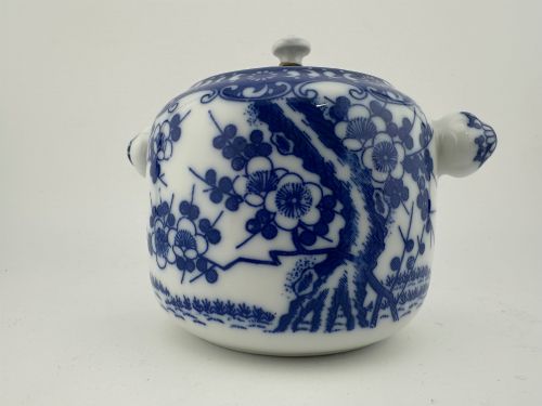 fig 1. A Japanese Meiji period blue and white porcelain incense burner decorated with hand-painted prunus branches, featuring a fitted lid and side lugs.
