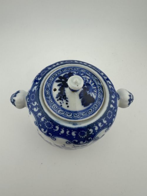 fig 2. A Japanese Meiji period blue and white porcelain incense burner decorated with hand-painted prunus branches, featuring a fitted lid and side lugs.