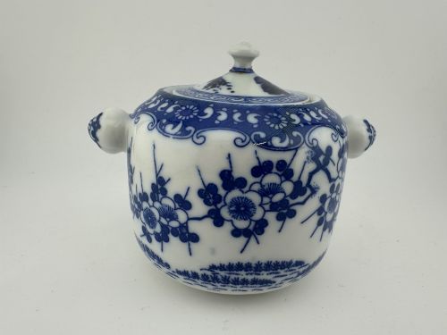 fig 4. A Japanese Meiji period blue and white porcelain incense burner decorated with hand-painted prunus branches, featuring a fitted lid and side lugs.