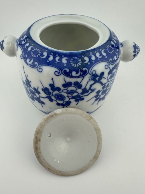 fig 6. A Japanese Meiji period blue and white porcelain incense burner decorated with hand-painted prunus branches, featuring a fitted lid and side lugs.