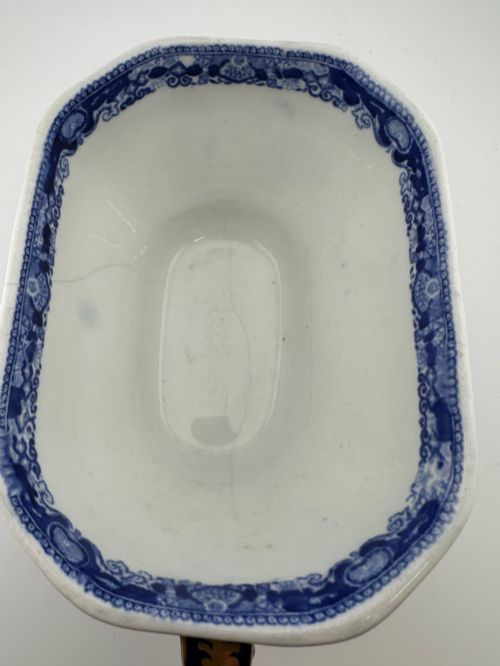 fig 3. An antique oval ironstone jardiniere featuring blue and white transfer-printed Chinoiserie landscape decoration and small side handles with gilded detailing.