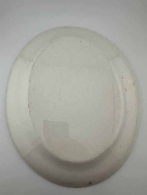 fig 6. An early Victorian oval earthenware platter featuring a pale blue floral transferware border pattern and a gilded outer rim.