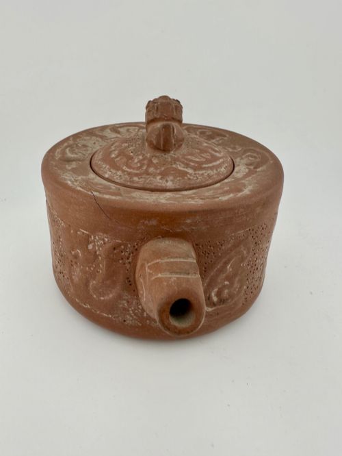 fig 3. An antique brown Zisha clay teapot featuring archaistic relief decoration and a toad finial on the lid.
