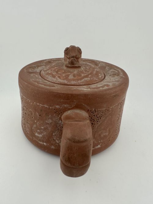 fig 5. An antique brown Zisha clay teapot featuring archaistic relief decoration and a toad finial on the lid.
