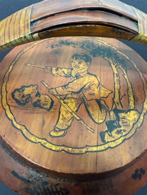 fig 2. A three-tiered late 19th-century Chinese bamboo and wood food carrier with an arched handle, featuring hand-painted yellow flowers, birds, and goldfish against a warm brown lacquer finish.