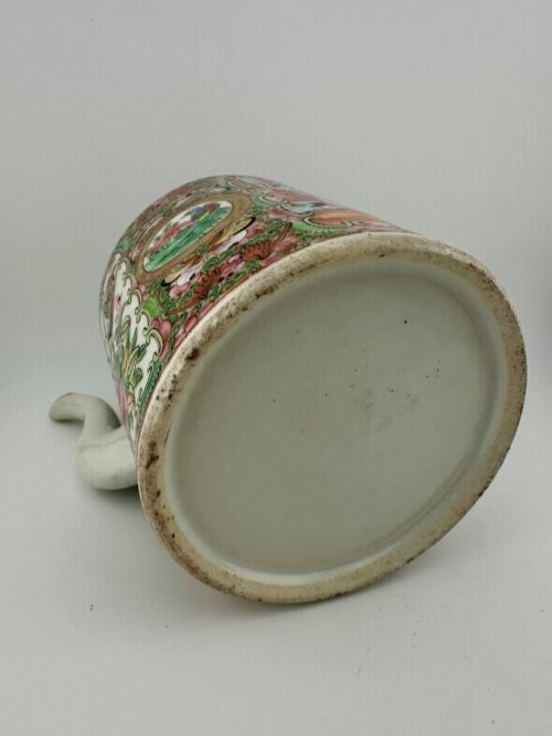 fig 4. A Chinese Famille Rose cylindrical ceramic teapot with hand-painted court figures set beside its fitted woven wicker carrying case.