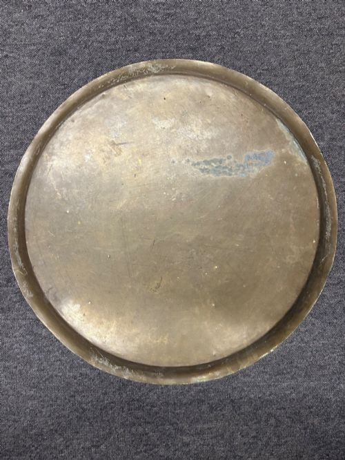 fig 3. A large circular brass tray featuring intricate hand-engraved concentric floral and geometric patterns with a shallow rolled rim.