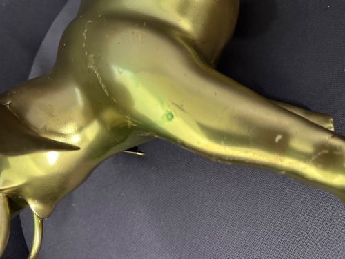 fig 6. A vintage cast brass elephant sculpture standing with its trunk raised high.