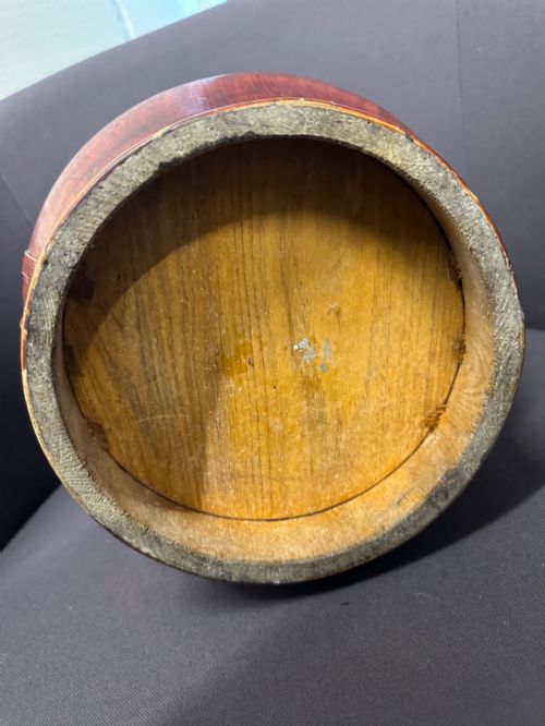 fig 6. A late Qing Dynasty tiered Chinese food basket crafted from warm amber bamboo and wood, hand-painted with black line illustrations of a child on the lid and floral motifs around the body.