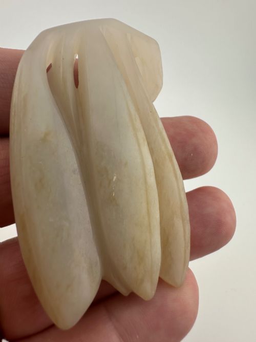 fig 5. A stylized 19th-century Chinese pale celadon jade carving depicting a cicada with a smooth polished finish.