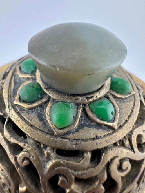 fig 8. An antique cast bronze Chinese censer featuring a pierced cover, beast-head handles, inlaid green hardstone petals, and a matching fitted bronze stand.