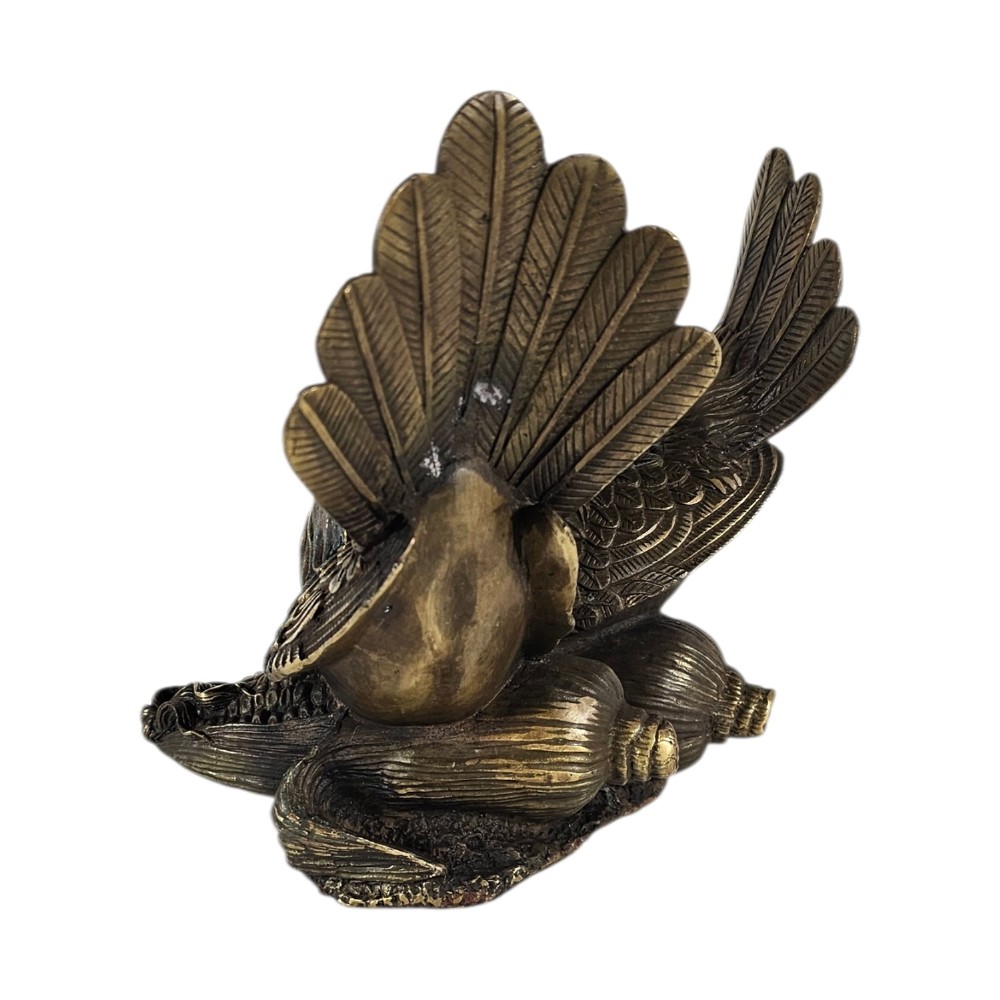 A pair of cast bronze doves with detailed feather chasing and fanned tail feathers perched together on a maize cob base. View II