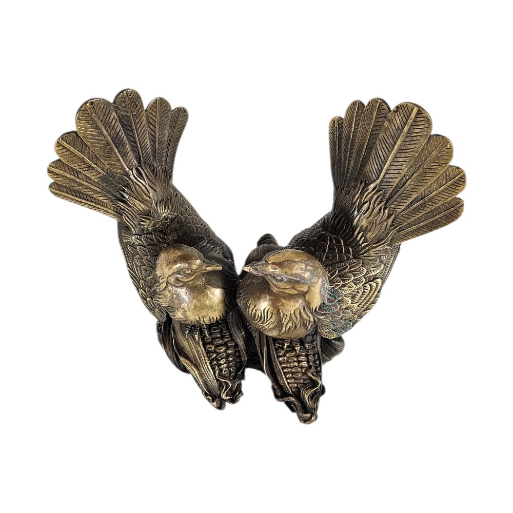 A pair of cast bronze doves with detailed feather chasing and fanned tail feathers perched together on a maize cob base. View III