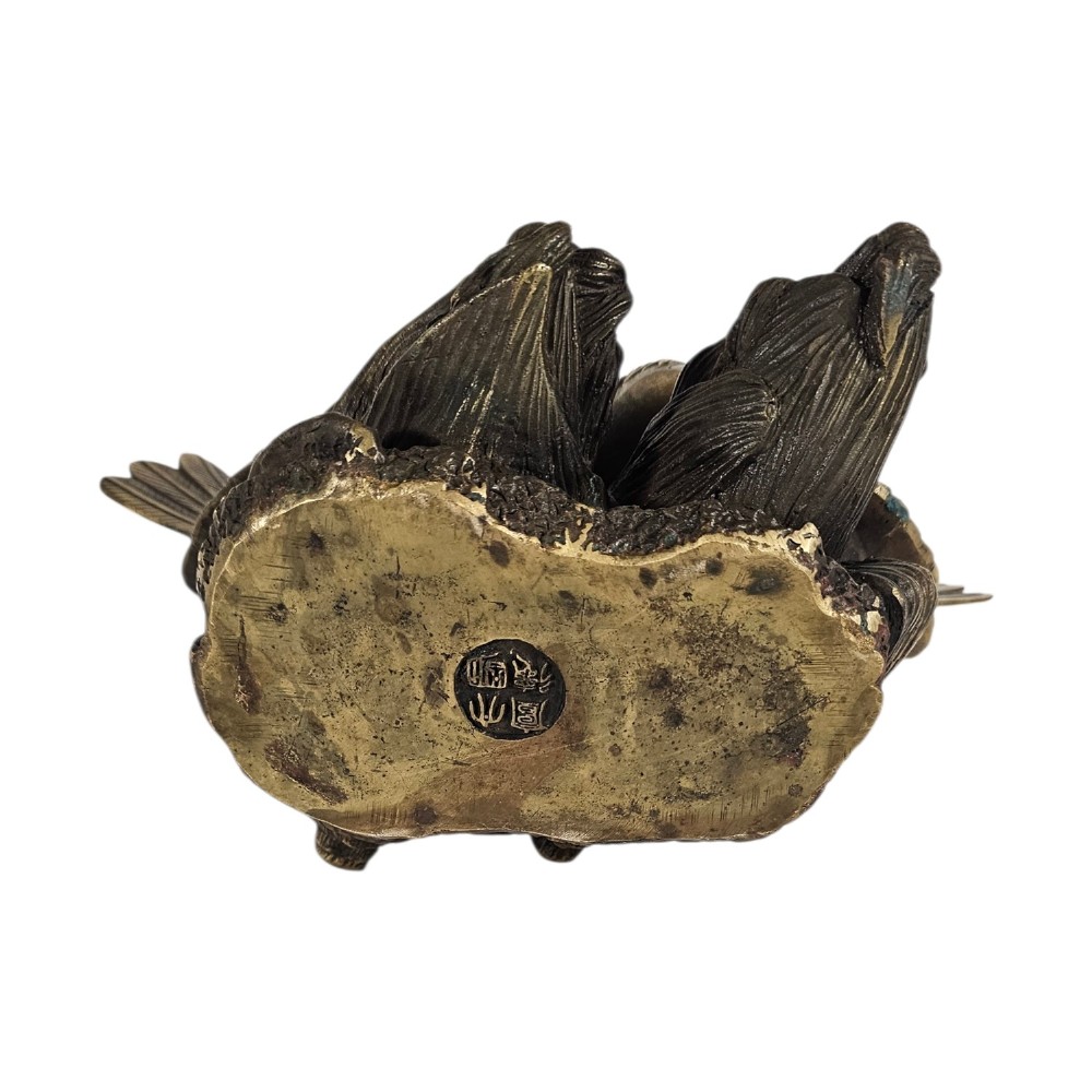A pair of cast bronze doves with detailed feather chasing and fanned tail feathers perched together on a maize cob base. View IV