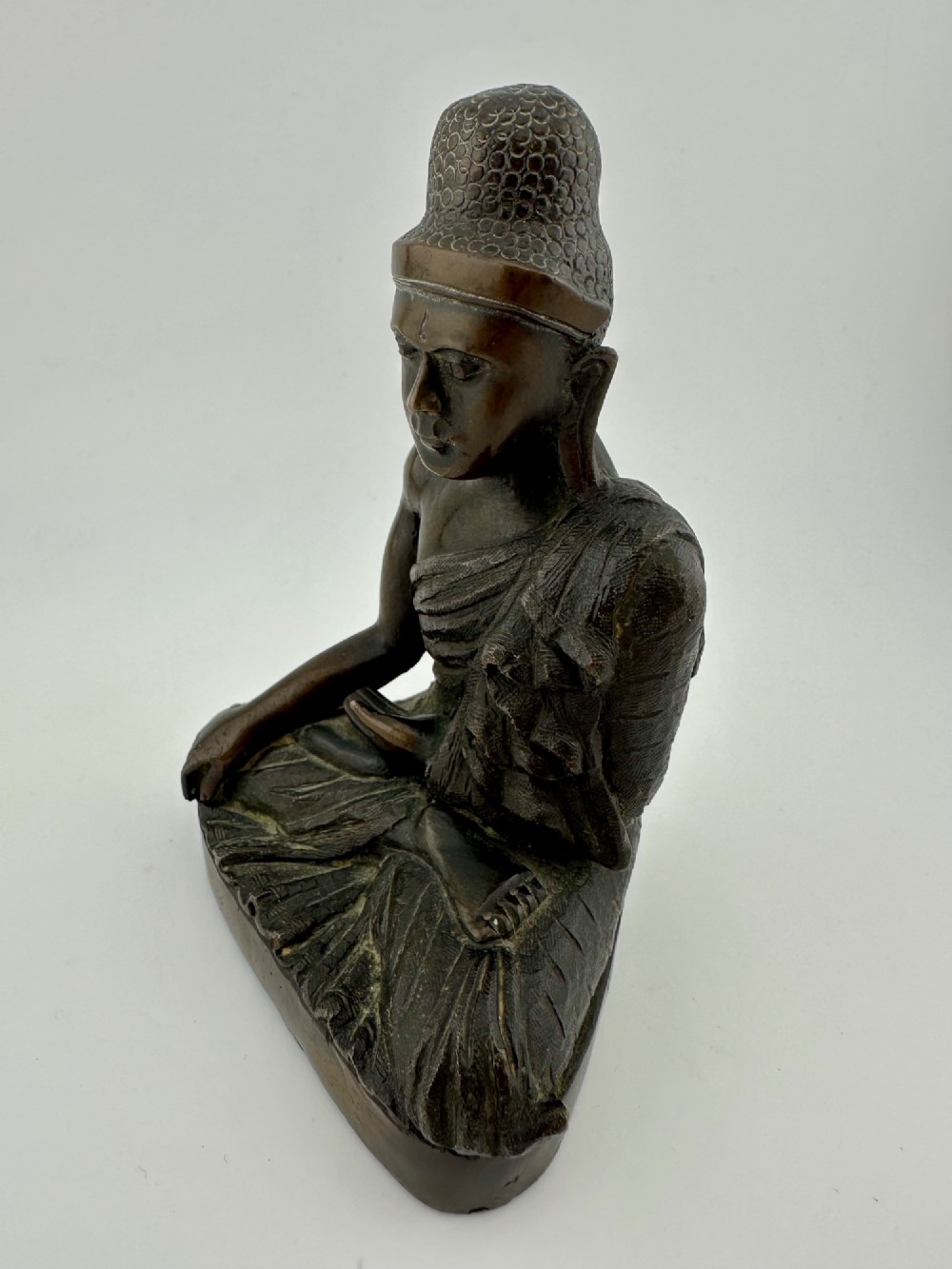 A 19th-century Burmese cast bronze seated Shakyamuni Buddha statue depicting the Bhumisparsha mudra with a dark patinated finish. View II