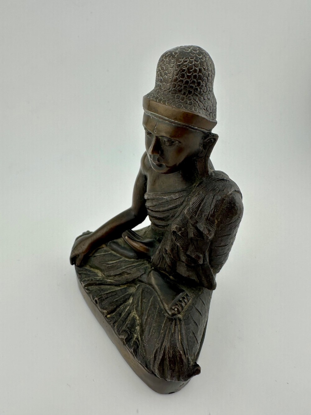 A 19th-century Burmese cast bronze seated Shakyamuni Buddha statue depicting the Bhumisparsha mudra with a dark patinated finish. View III