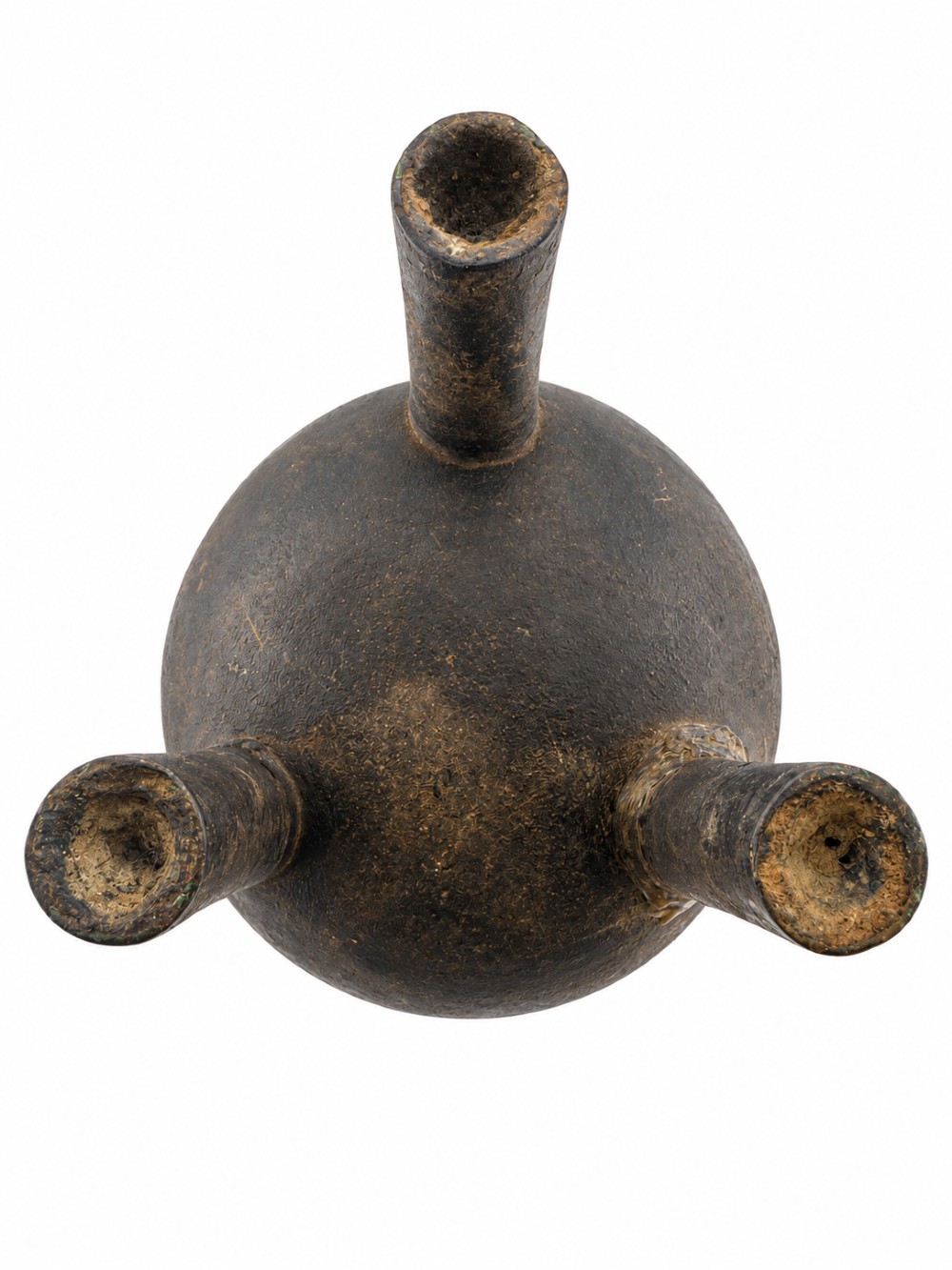 A dark patinated bronze tripod ding censer featuring three cylindrical legs, twin upright handles, and carved taotie mask relief decoration around the upper body. View V