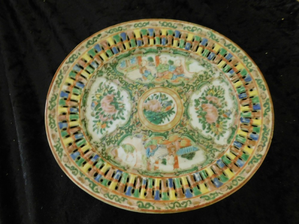 A 19th-century Chinese Famille Rose reticulated porcelain basket and matching pierced underplate decorated with polychrome floral and figurative motifs. View II