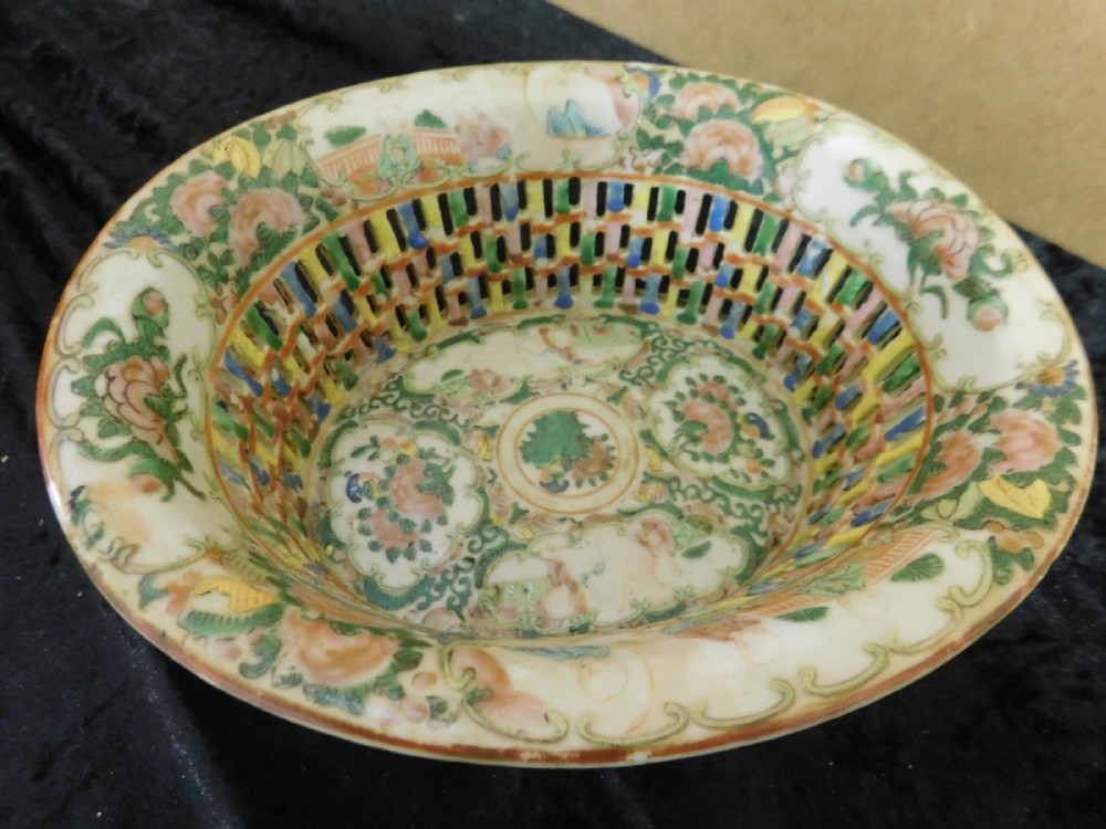 A 19th-century Chinese Famille Rose reticulated porcelain basket and matching pierced underplate decorated with polychrome floral and figurative motifs. View III