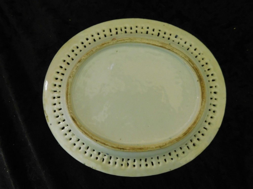 A 19th-century Chinese Famille Rose reticulated porcelain basket and matching pierced underplate decorated with polychrome floral and figurative motifs. View VI