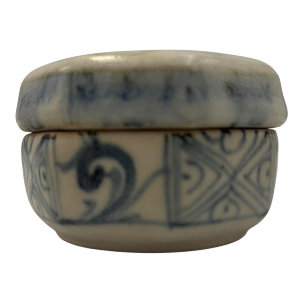 Small octagonal ceramic covered box featuring off-white glaze and hand-painted blue cobalt scroll motifs. View II