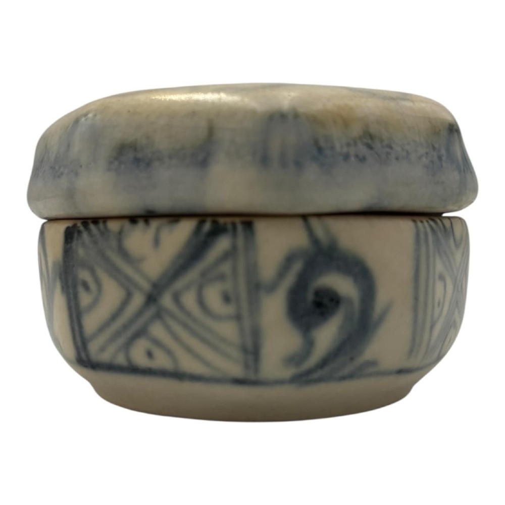 Small octagonal ceramic covered box featuring off-white glaze and hand-painted blue cobalt scroll motifs. View III