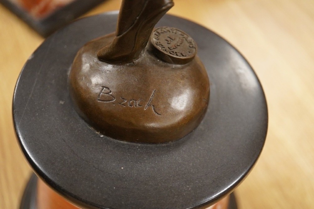 An Art Deco style bronze sculpture of a female dancer in mid-leap mounted on a rounded variegated orange marble base. View II