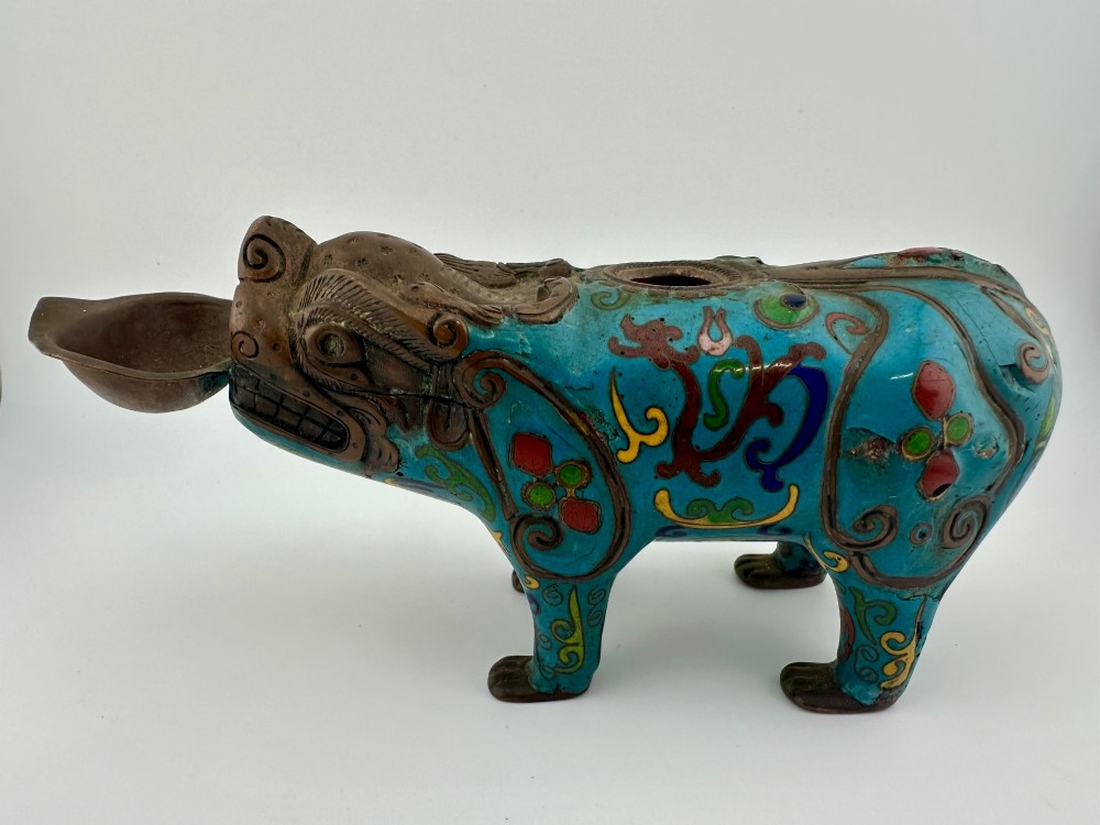 An antique Chinese bronze censer shaped as a mythical beast decorated with turquoise cloisonne enamel and colourful scrollwork.