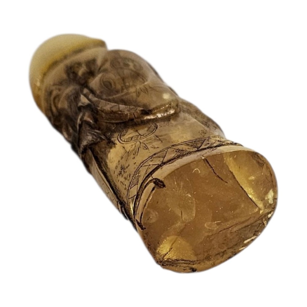 A hand-carved honey amber pendant depicting the Chinese deity Shoulao with incised robe detailing and a high domed head. View III