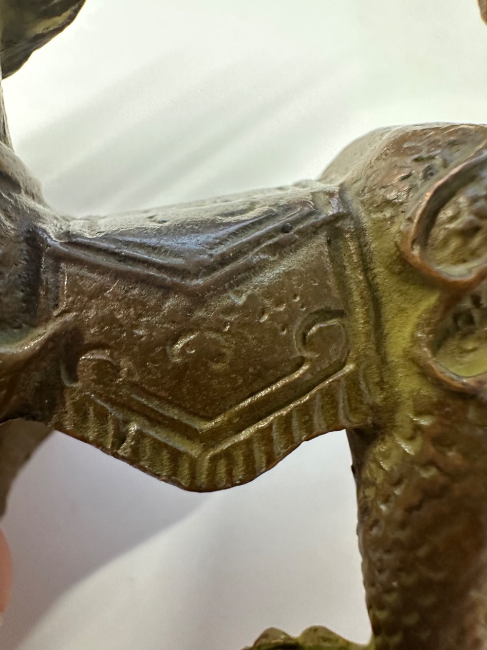 A small patinated dark brown bronze figure of a Chinese mythical beast, standing on four legs with an open mouth and raised tail. View XIII