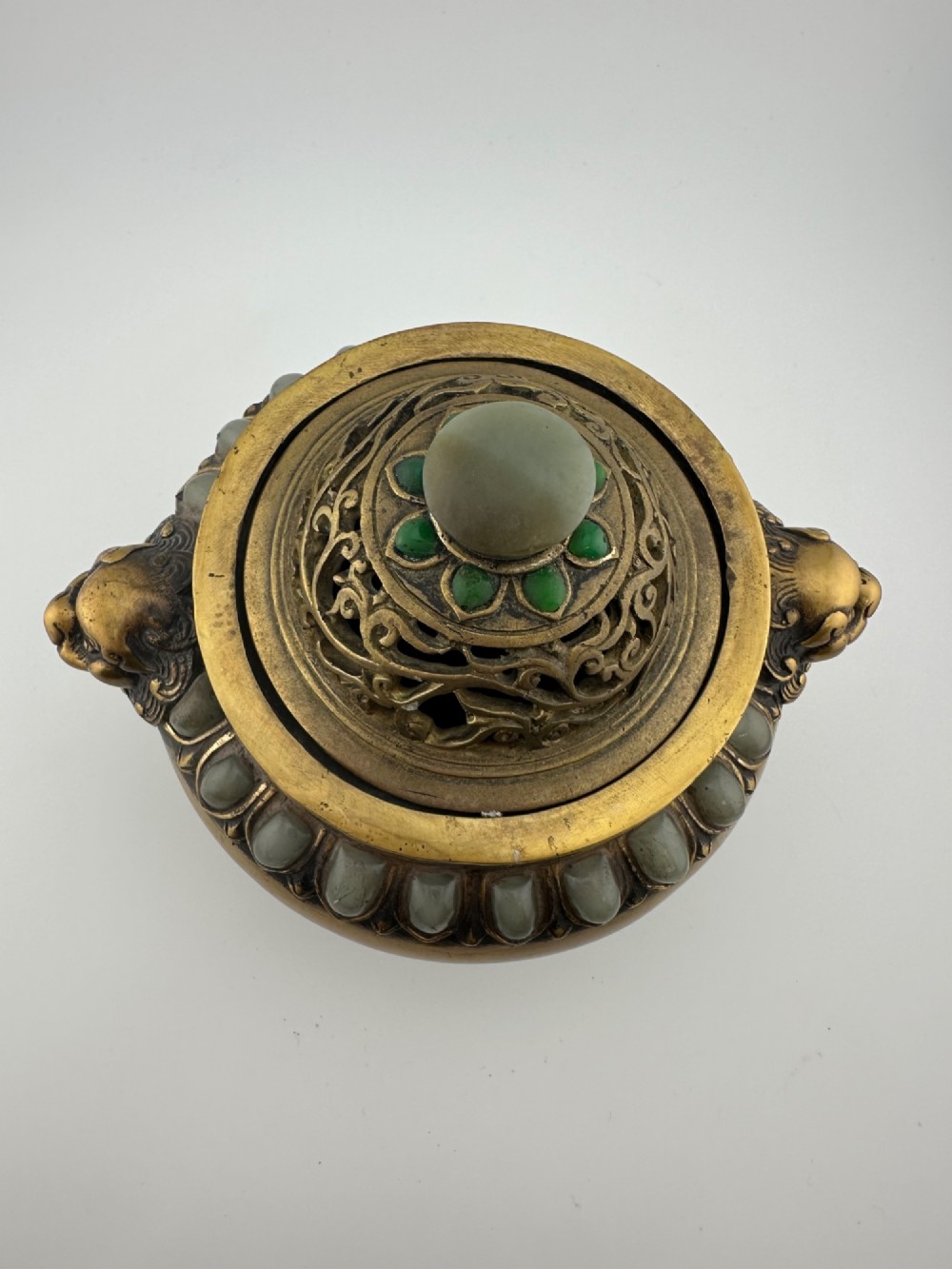 An antique gilded bronze Chinese censer featuring hardstone and jade cabochon inlays, beast-head handles, a pierced cover, and a matching carved stand. View III